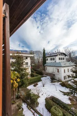 a view from the balcony of a house with snow on the ground at Modern studio apartment in the heart of Merano in Merano