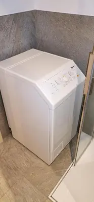 a white refrigerator sitting on top of a floor at Ritschhof in Castelrotto