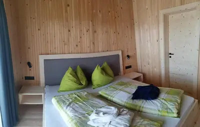 a bedroom with a bed with green pillows at Ritschhof in Castelrotto