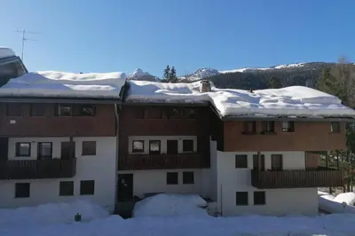 a building with snow on top of it at Wonderful Attic in Dolomite's Heart in Selva di Cadore