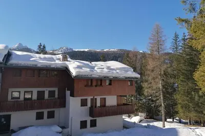 a house with snow on the roof at Wonderful Attic in Dolomite's Heart in Selva di Cadore