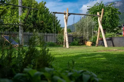 a swing set in a yard with a fence at Weingut Lahn zu Eppan in Appiano sulla Strada del Vino