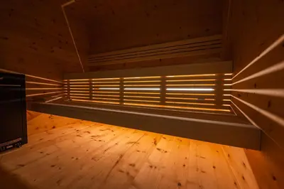 an empty room with a bench in a room with wooden floors at Weingut Lahn zu Eppan in Appiano sulla Strada del Vino