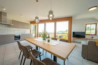 a kitchen and dining room with a wooden table and chairs at Weingut Lahn zu Eppan in Appiano sulla Strada del Vino