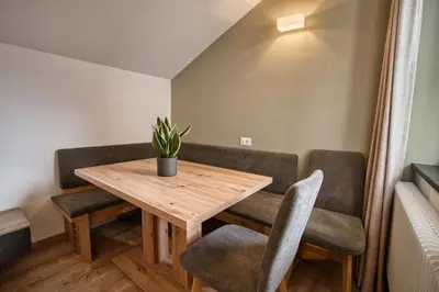 a kitchen with white cabinets and a sink at byRosi Apartments in Parcines