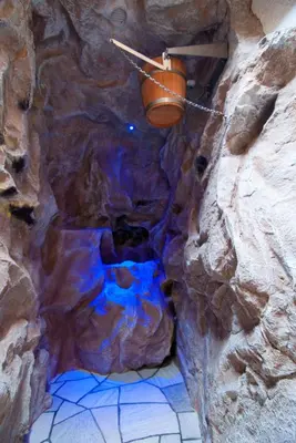 a stone cave with a bucket on the ceiling at Apartments Sunela in Selva di Val Gardena