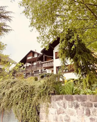 a house on top of a stone wall at Appartamenti Pichler in Castello di Fiemme