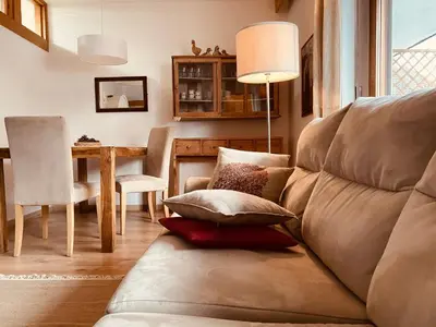 a living room with a couch and a table at Appartamenti Pichler in Castello di Fiemme