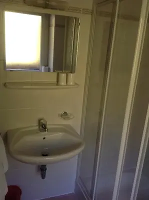 a bathroom with a sink and a shower at Gasthof Bundschen in Sarntal