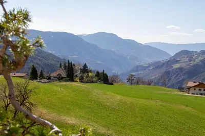 a green field with mountains in the background at Residence Villa Schlern in Fiè