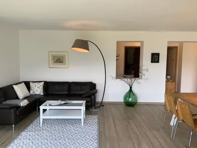 a living room with a black couch and a table at Residence Villa Schlern in Fiè