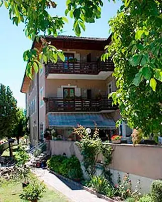 an apartment building with a balcony and a building at Hotel Garni Christin in Ora/Auer