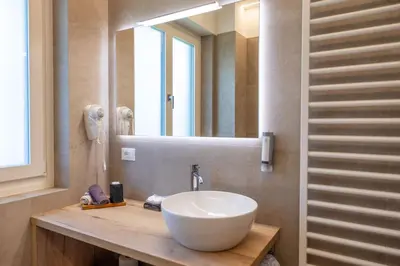 a bathroom with a white sink and a mirror at Villa Vera in Ora/Auer