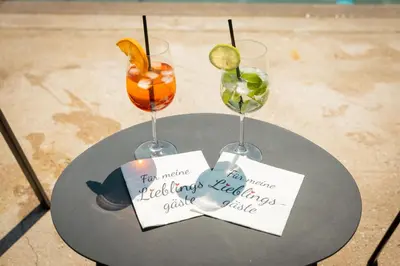 a table with two wine glasses and signs on it at Villa Vera in Ora/Auer