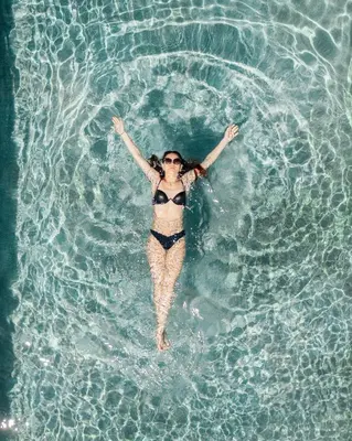 a woman is swimming in a pool of water at Villa Vera in Ora/Auer