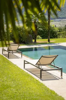 two lounge chairs sitting next to a swimming pool at Villa Vera in Ora/Auer