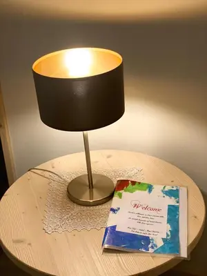a lamp sitting on top of a table with a book at Villa Vera in Ora/Auer