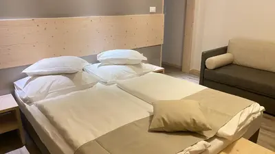 a hospital room with a bed and a couch at Villa Vera in Ora/Auer