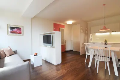 a living room with a couch and a dining room at Residence Sonneckhof in Caldaro