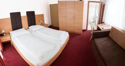 a bedroom with a bed and a couch at Gasthaus Abram in Ora/Auer