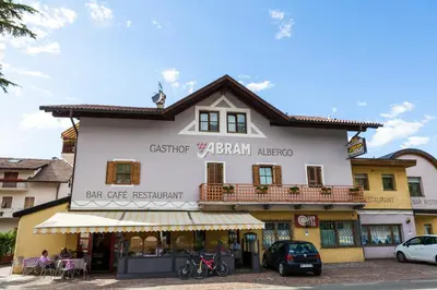 a building with a sign for a restaurant at Gasthaus Abram in Ora/Auer