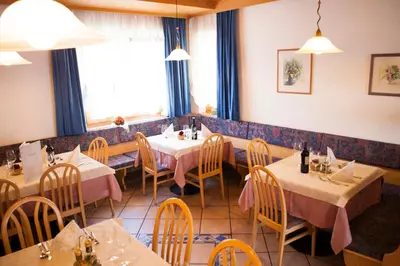 a restaurant with tables and chairs in a room at Gasthaus Abram in Ora/Auer
