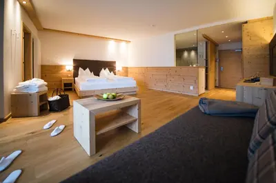 a bathroom with two sinks and a large mirror at Hotel Fischer in Bressanone