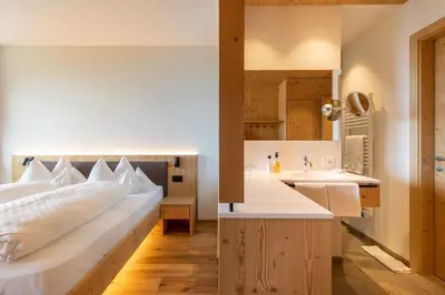 a bathroom with a sink and a toilet at Hotel Fischer in Bressanone