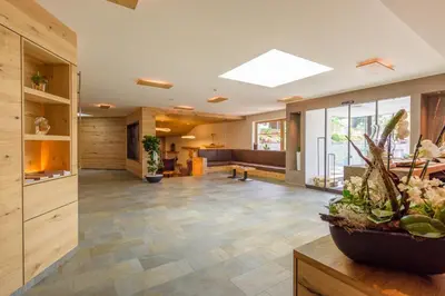 a large lobby with a skylight in a house at Hotel Fischer in Bressanone