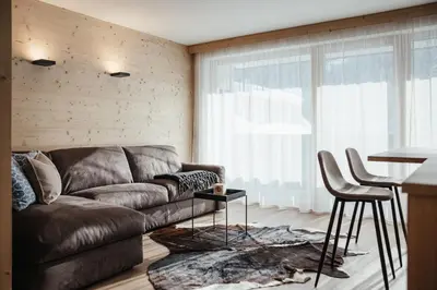 a living room with a couch and a table at Appartamenti Ciasa Hanny in Colfosco