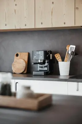 a kitchen counter with a coffee maker and utensils at Appartamenti Ciasa Hanny in Colfosco