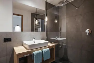 a bathroom with a sink and a mirror at Appartamenti Ciasa Hanny in Colfosco