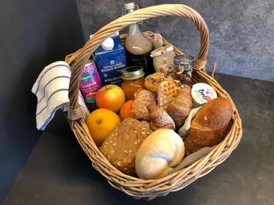 a basket filled with different types of bread and fruit at Appartamenti Ciasa Hanny in Colfosco