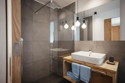 a bathroom with a sink and a shower at Appartamenti Ciasa Hanny in Colfosco