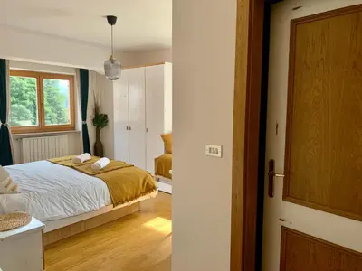 a bedroom with a bed and a window at Casa di Franz in Vigo di Fassa