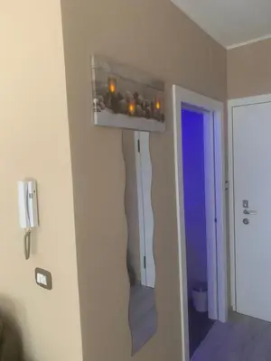 a room with a hallway with a wall with a mirror at Dolce Vista in Merano