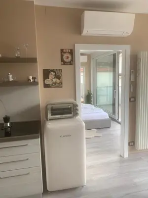 a room with a refrigerator next to a bed at Dolce Vista in Merano