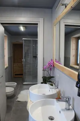 a bathroom with two sinks and two toilets at Chalet Margoni in Canazei