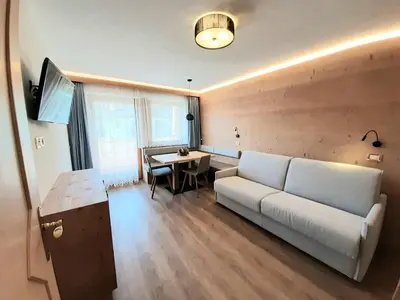 a living room with a couch and a table at Apartments Lasteis in La Villa