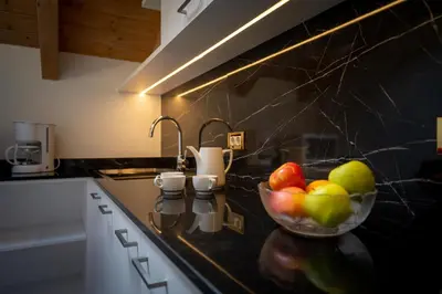 a bowl of fruit on a counter in a kitchen at Apartments Lasteis in La Villa