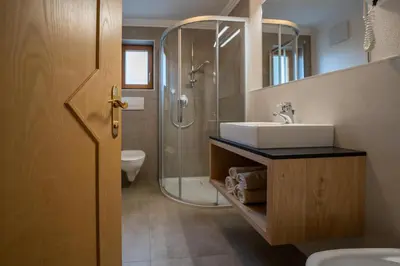 a bathroom with a sink and a shower at Apartments Lasteis in La Villa