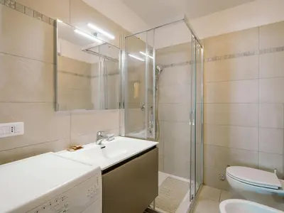 a bathroom with a sink and a washing machine at Apartment Condominio al Parco-9 by Interhome in Canazei