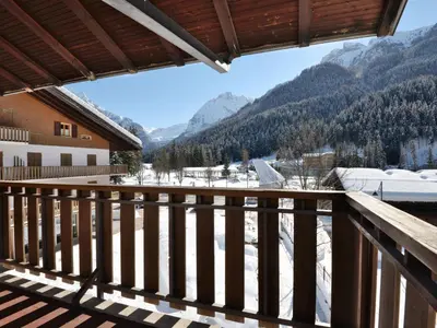 a building with a balcony on the side of it at Apartment Condominio al Parco-9 by Interhome in Canazei