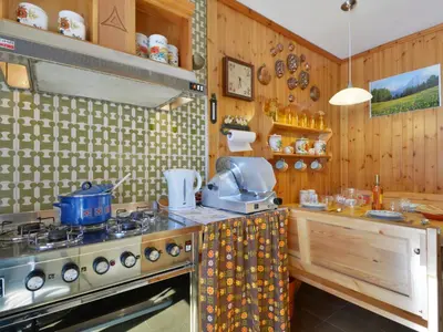 a kitchen with a stove and a sink and a counter at Apartment Condominio al Parco-9 by Interhome in Canazei