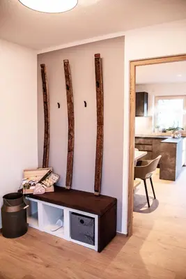 a living room with a wall with four logs at Apartment Schifta in Chienes