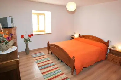 a bedroom with a bed and a vase of flowers at Casa Lisa in Falcade