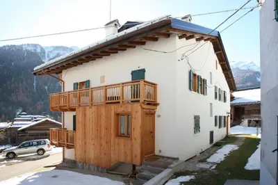 a house with a deck on the side of it at Casa Lisa in Falcade