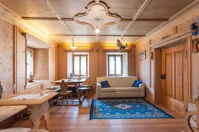 a living room with a table and a couch at Cesa al Monech in Selva di Cadore