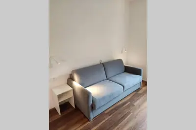 a living room with a blue couch in a room at Appartment Barbara in Bolzano