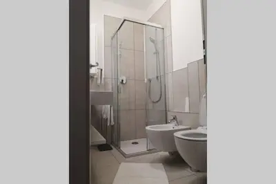 a bathroom with a shower and a toilet and a sink at Appartment Barbara in Bolzano